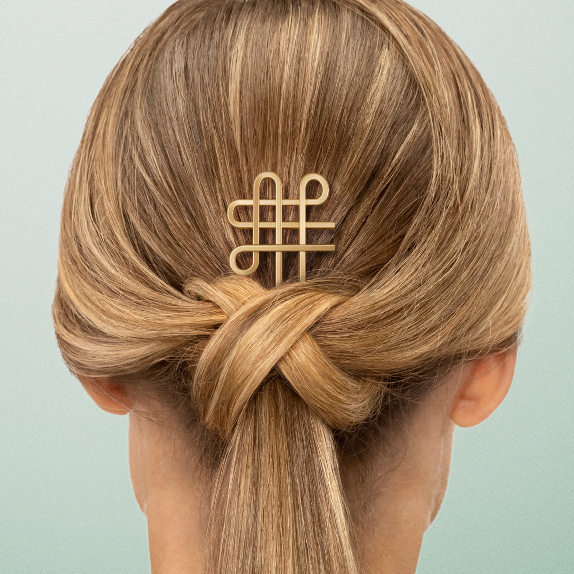 Blonde hair in knot with hair pin